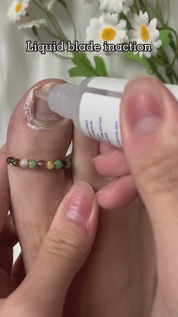 Cream bottle applied around toes, then a white-collar purple-tip tool cleans the nail edges. Beaded toe ring and daisies in background. Third-party product footage sourced from LuxAura. Original markings retained; no Erilas customer identity claimed.